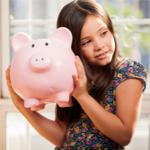 girl holding her piggy bank